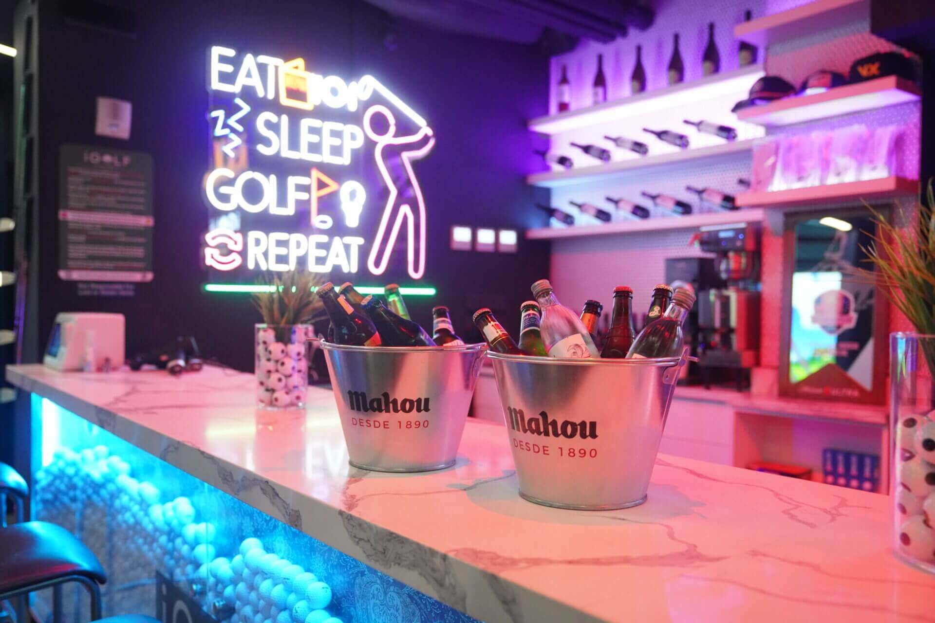 Neon bar signage and drink buckets